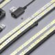 Line drawing comparing a USB-powered 5 V LED strip with dense pixel spacing against a 12 V strip with dual power-injection for long runs.