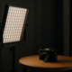 DIY LED strip photography panel lighting a product on a tabletop in a small studio