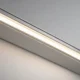 Close-up linear lighting installation showing a smooth, continuous line of light in an architectural channel